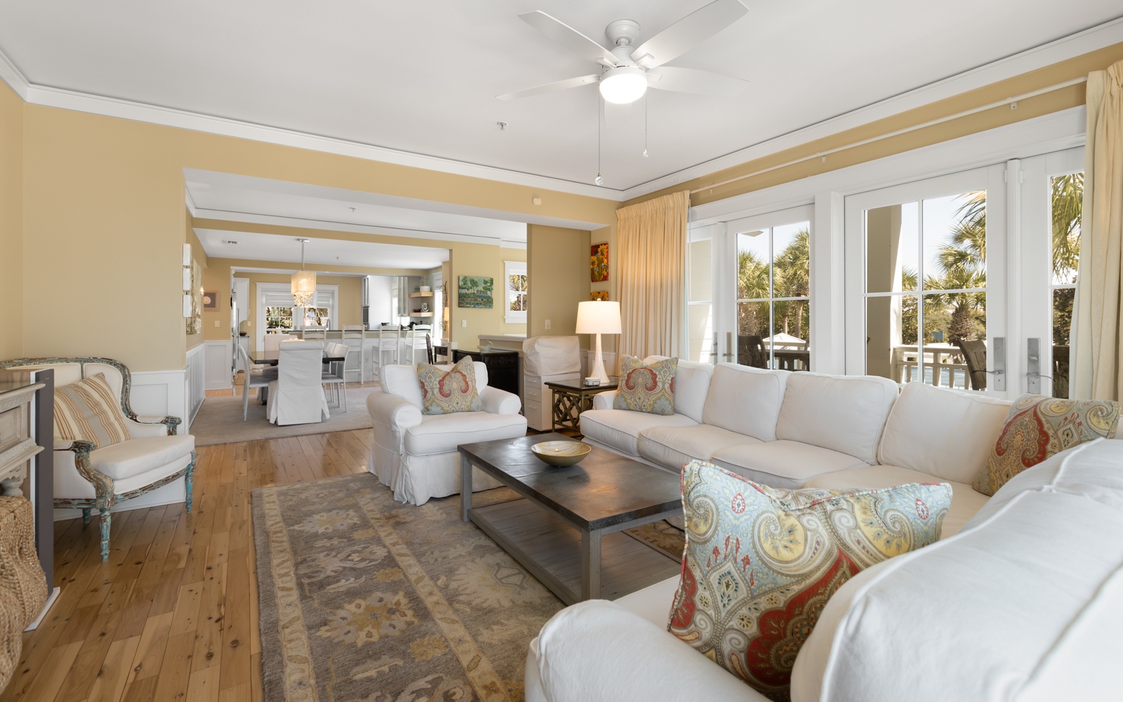 Unwind in your spacious living room with plush seating and tropical views through French doors leading to your private balcony.