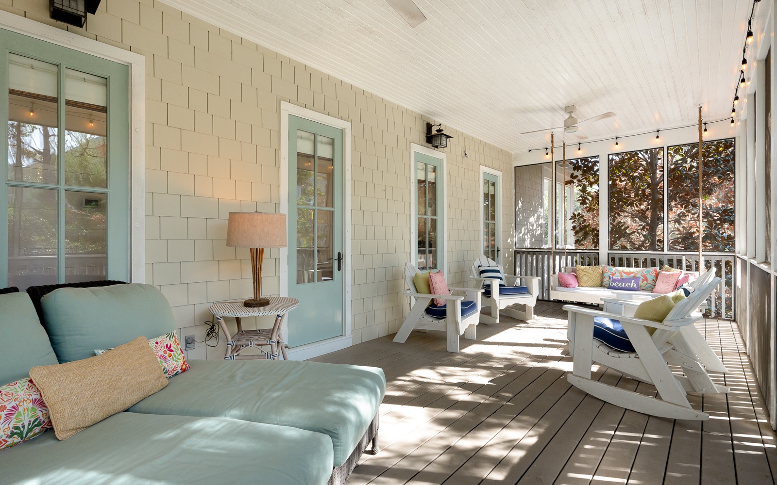 Unwind on your screened porch with coastal charm - colorful cushions, gentle breezes, and peaceful garden views create the perfect retreat.
