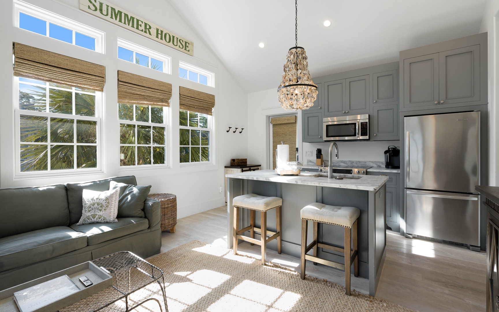 Your charming open-plan space blends coastal comfort with modern convenience, featuring a fully equipped kitchen and cozy seating area.