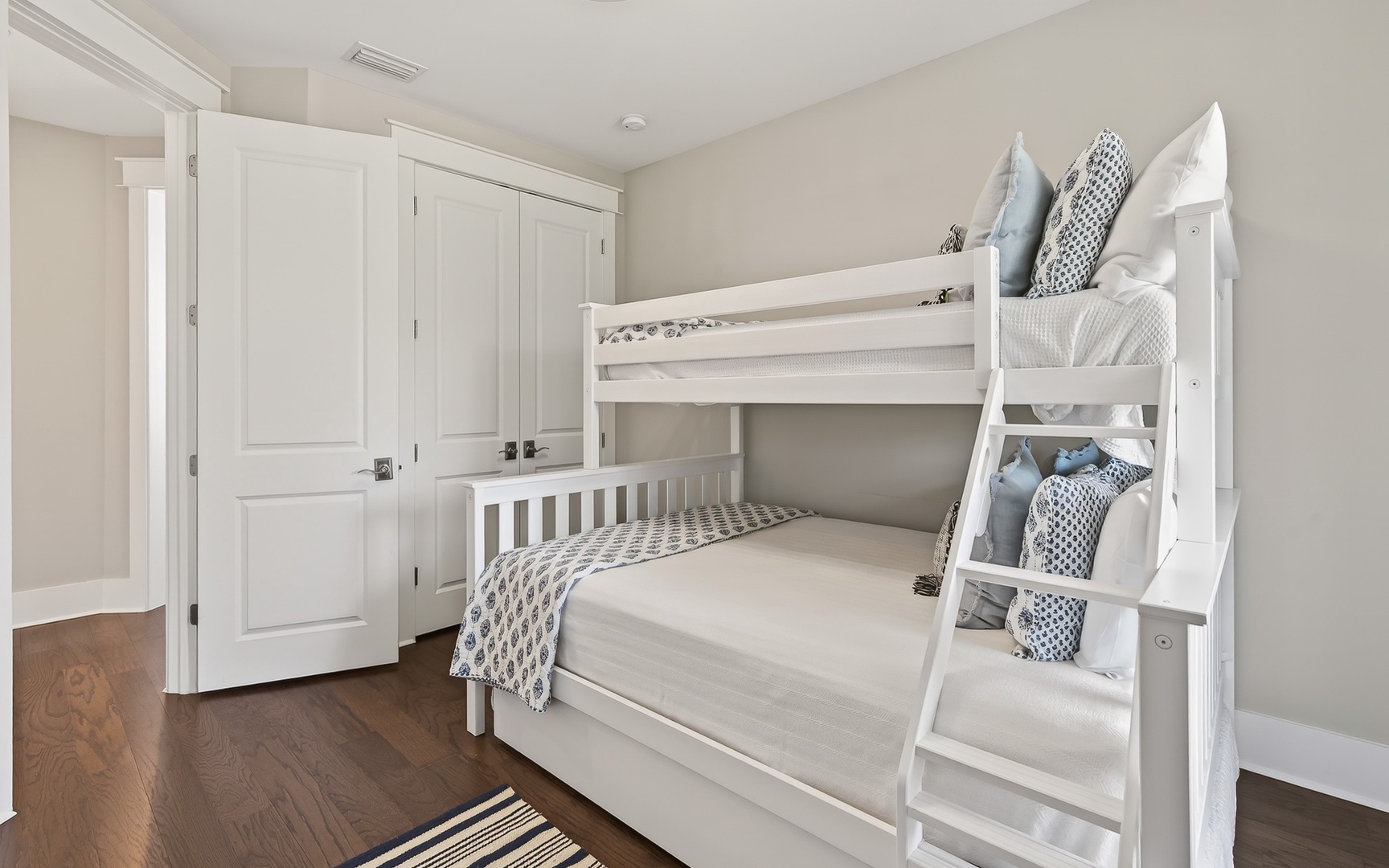 Your kids will love this cozy bunk room with soft linens and built-in storage for all their treasures.