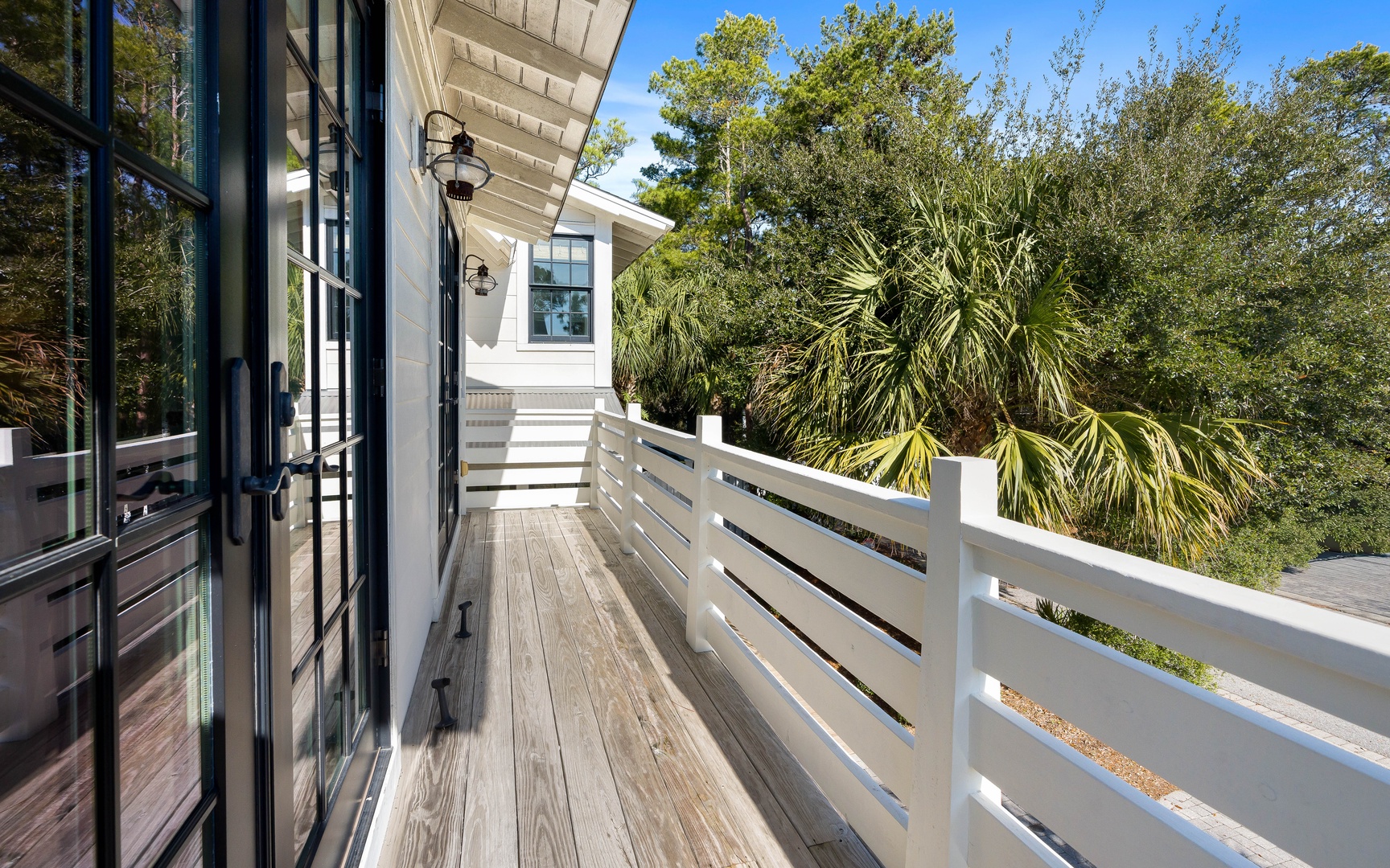Step onto your private balcony where morning coffee becomes a ritual among swaying palms and peaceful treetop views.