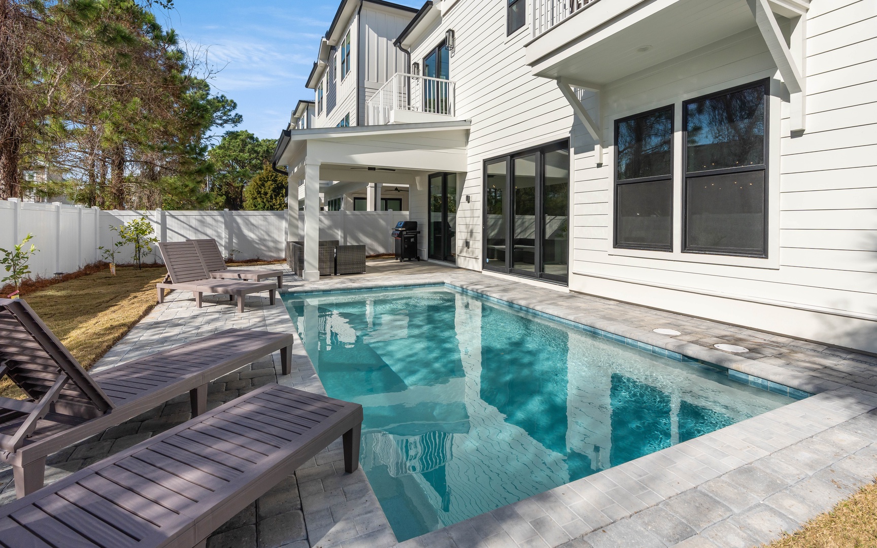 Dive into your private oasis with this sparkling pool surrounded by comfortable loungers, perfect for soaking up the Florida sunshine in your own backyard paradise.