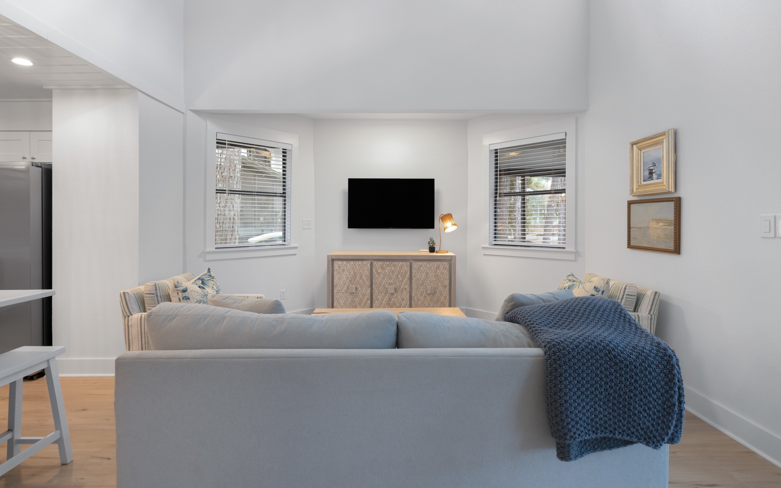 Relax in your stylish living room with plush seating, modern entertainment, and natural light streaming through windows.