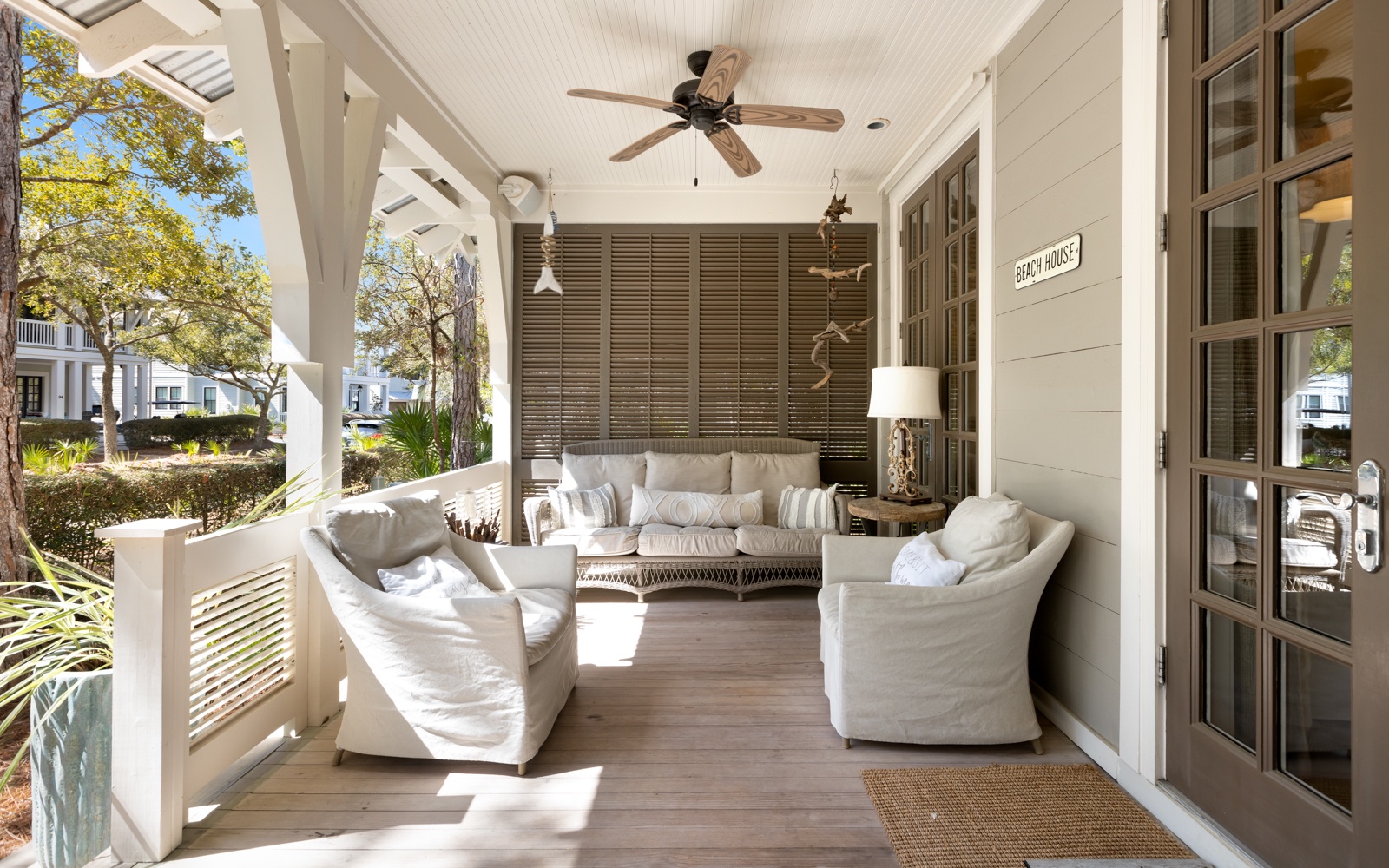 Your private covered porch invites relaxation with plush seating, ceiling fans, and peaceful neighborhood views.