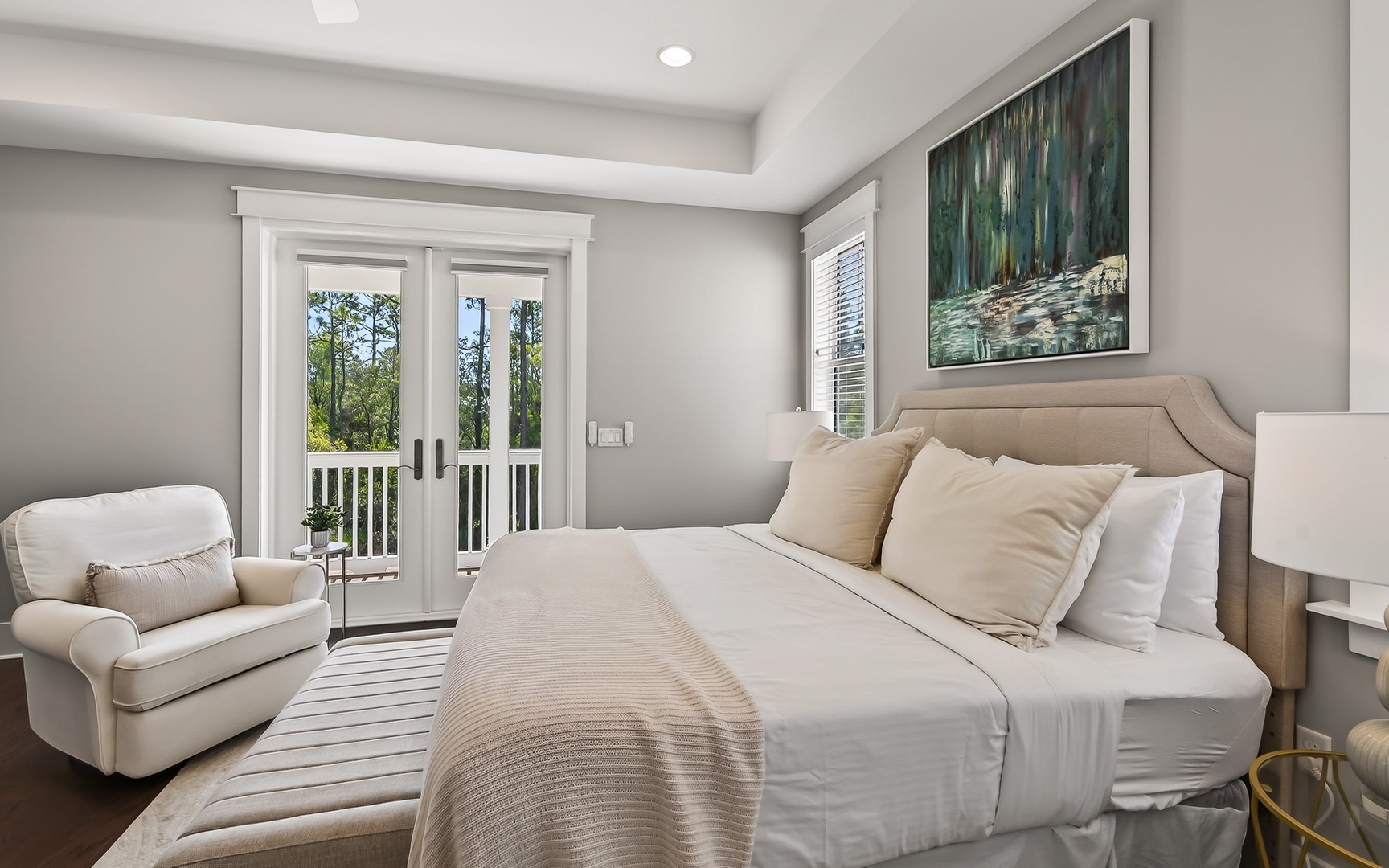 Sink into luxurious comfort in this serene bedroom, where plush bedding and a cozy reading chair create your perfect retreat.