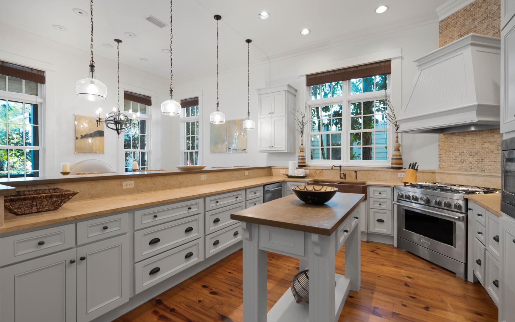Your spacious kitchen invites culinary adventures with gleaming countertops, modern appliances, and warm natural light streaming through charming windows.