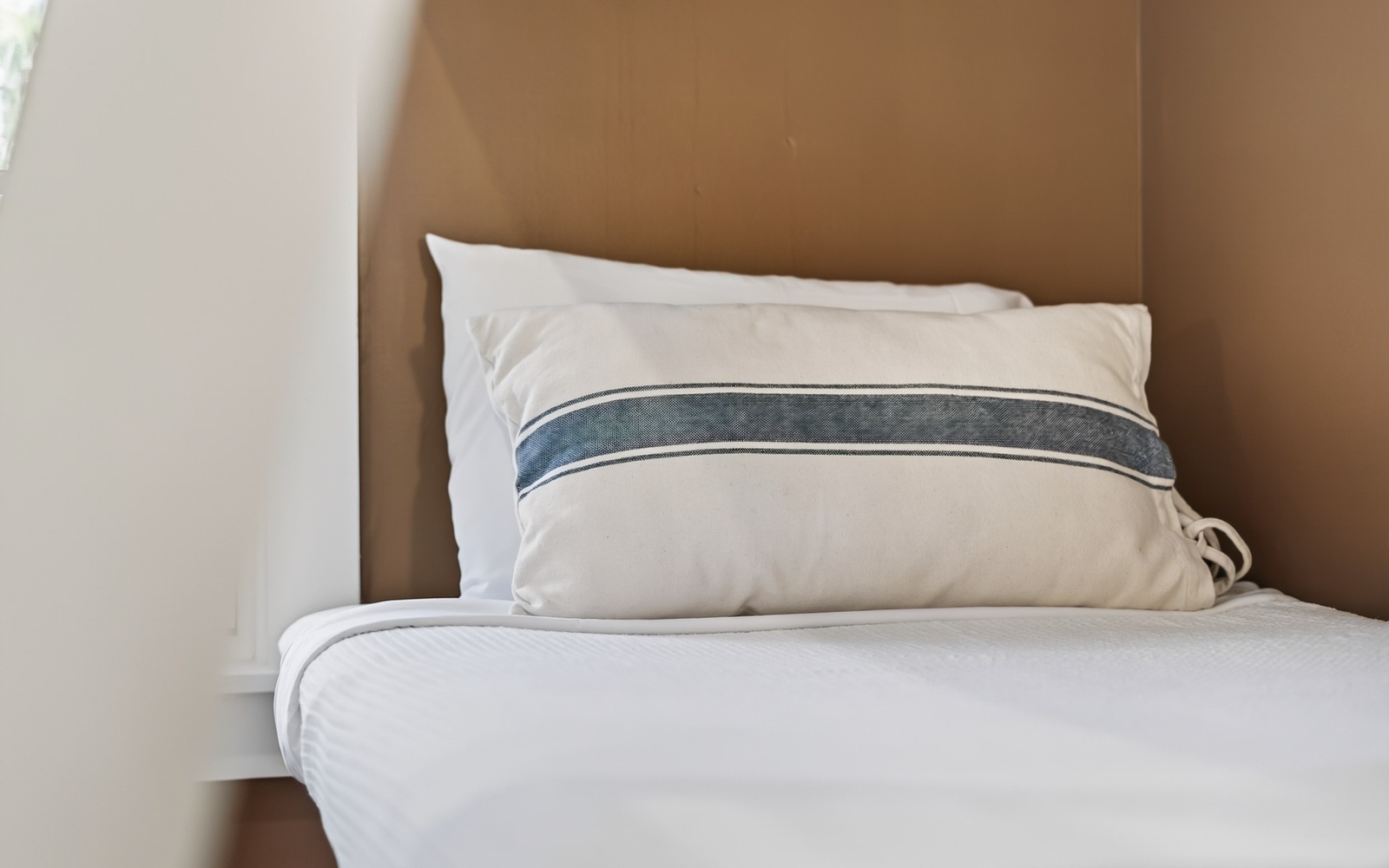 Sink into crisp white linens and soft pillows for a peaceful night's rest in your cozy bedroom retreat.