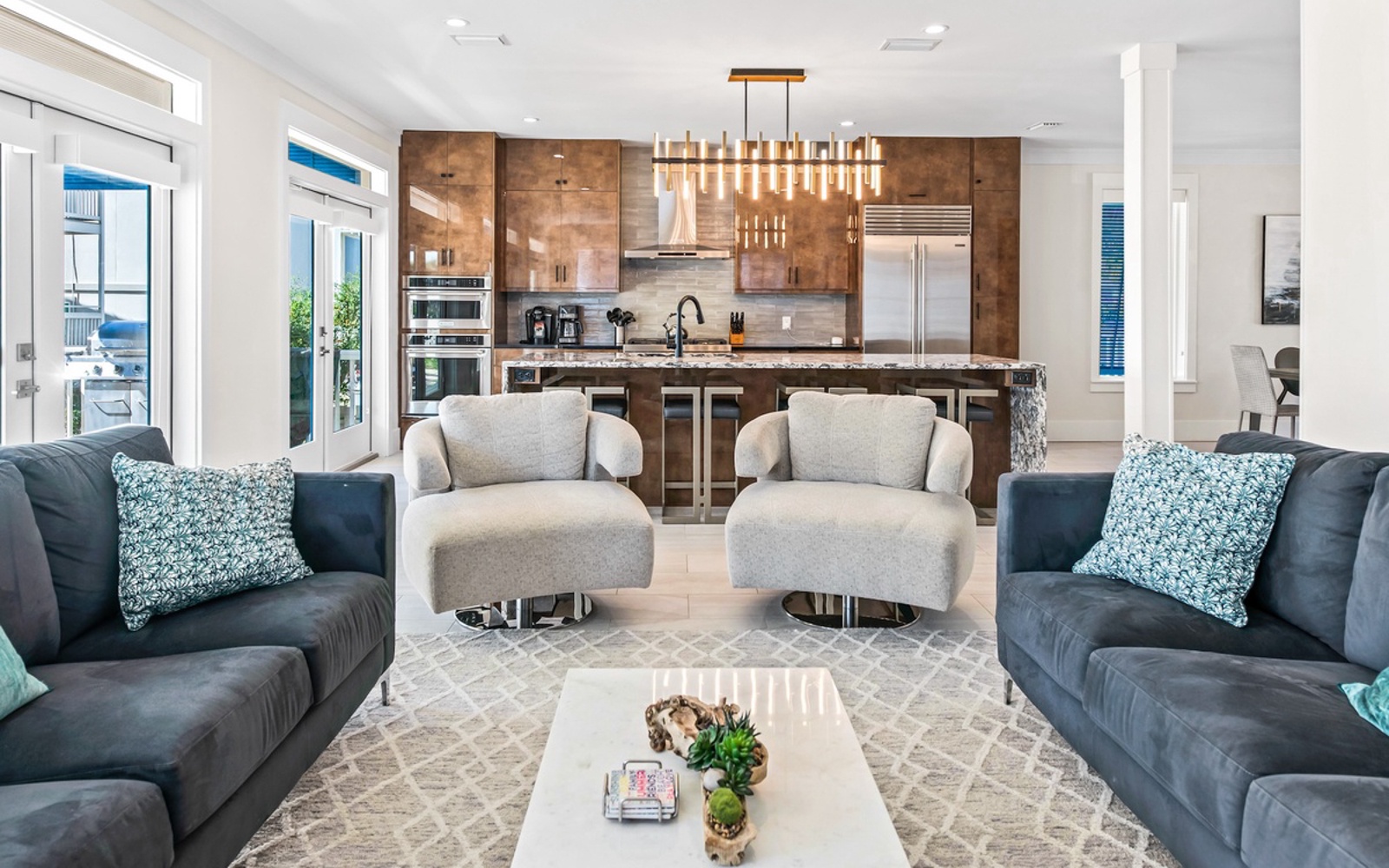 Your sophisticated living space flows seamlessly into a gourmet kitchen, where modern comfort meets coastal elegance in perfect harmony.