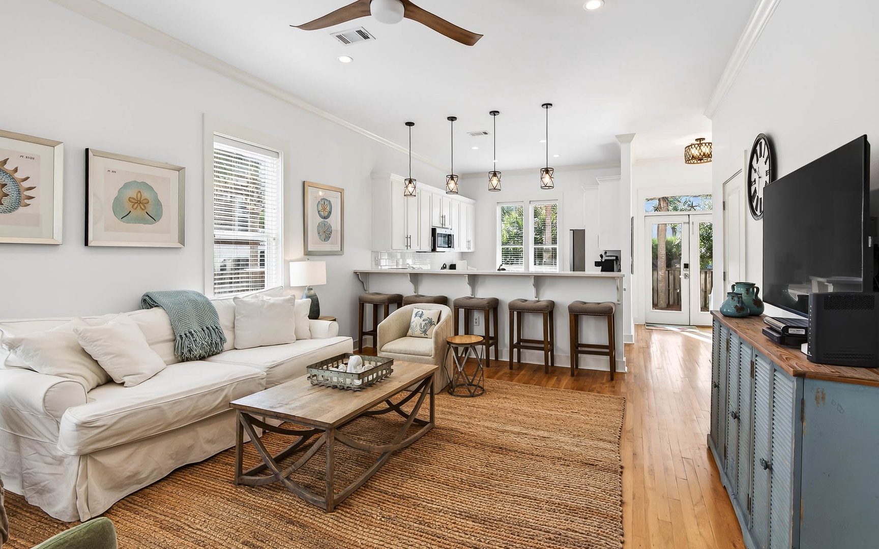 Unwind in your bright, coastal-inspired living space with plush seating, fully equipped kitchen, and charming details that make you feel right at home.