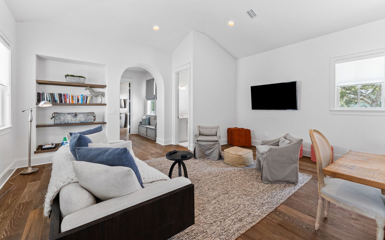 Unwind in your bright, thoughtfully designed living space with cozy seating, built-in shelving, and modern entertainment—perfect for relaxing after exploring.