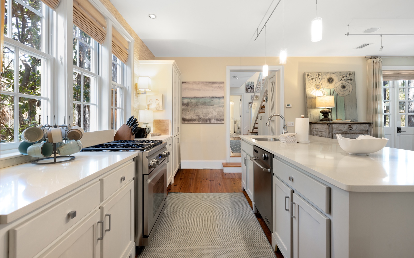 Cook with ease in this bright, open kitchen featuring modern appliances and pristine countertops flooded with natural light.