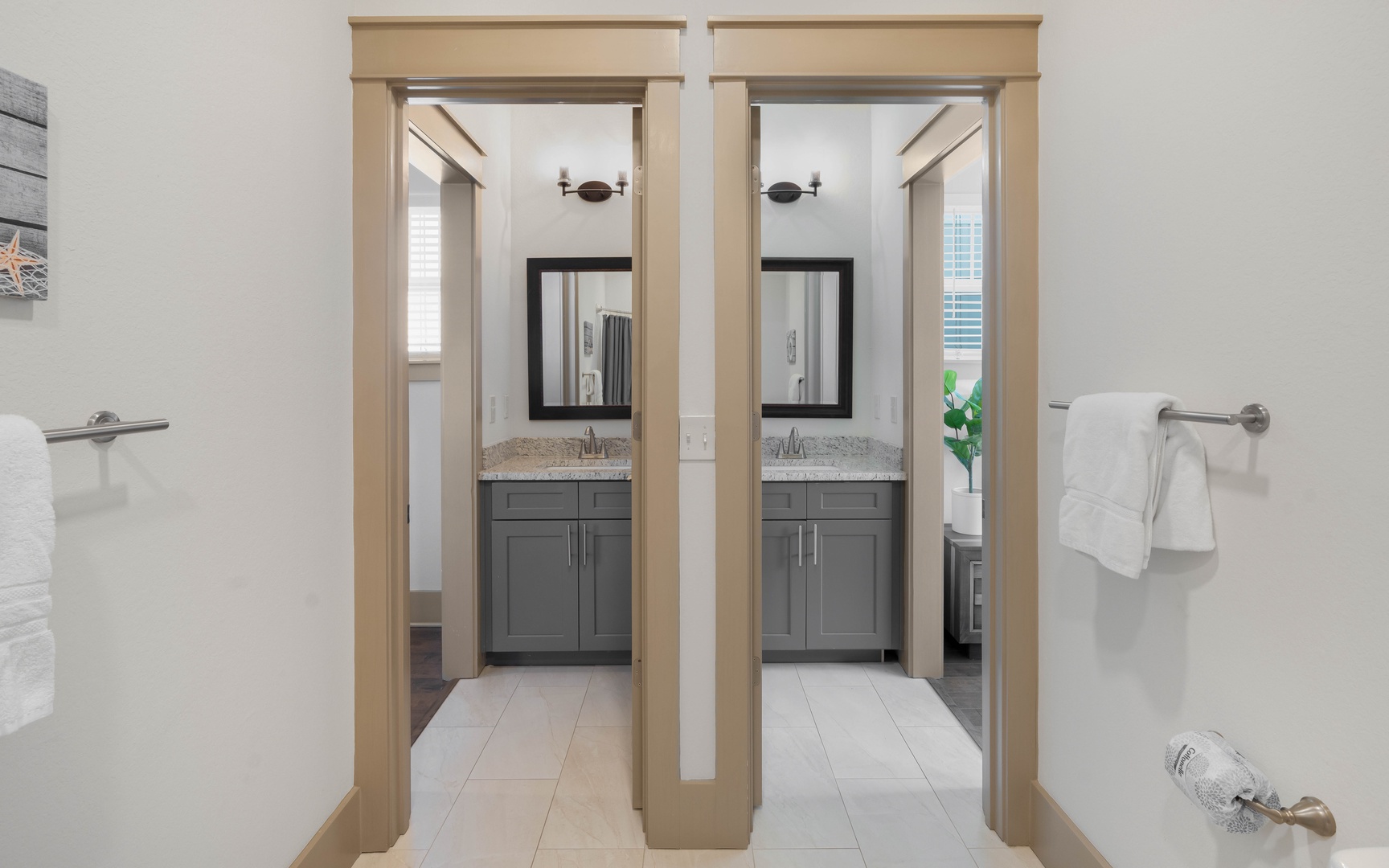 Unwind in your elegantly appointed bathroom featuring dual vanities with granite countertops and modern fixtures.