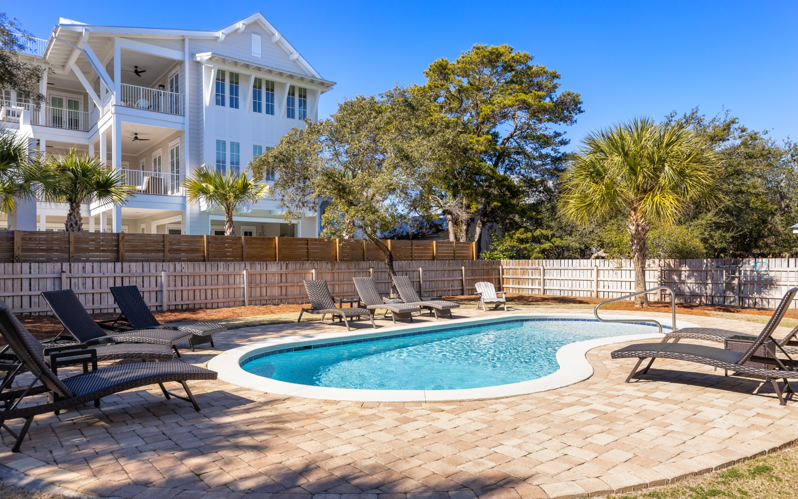 Sparkling pool surrounded by comfortable loungers invites you to soak up the sun in your private backyard oasis.