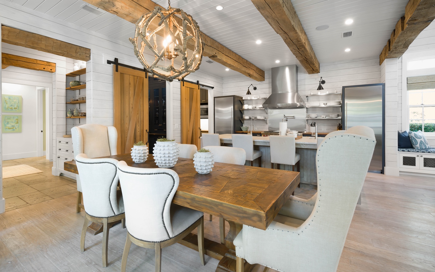 Gather around this stunning dining table where rustic wood beams meet modern elegance, creating the perfect space for memorable meals together.