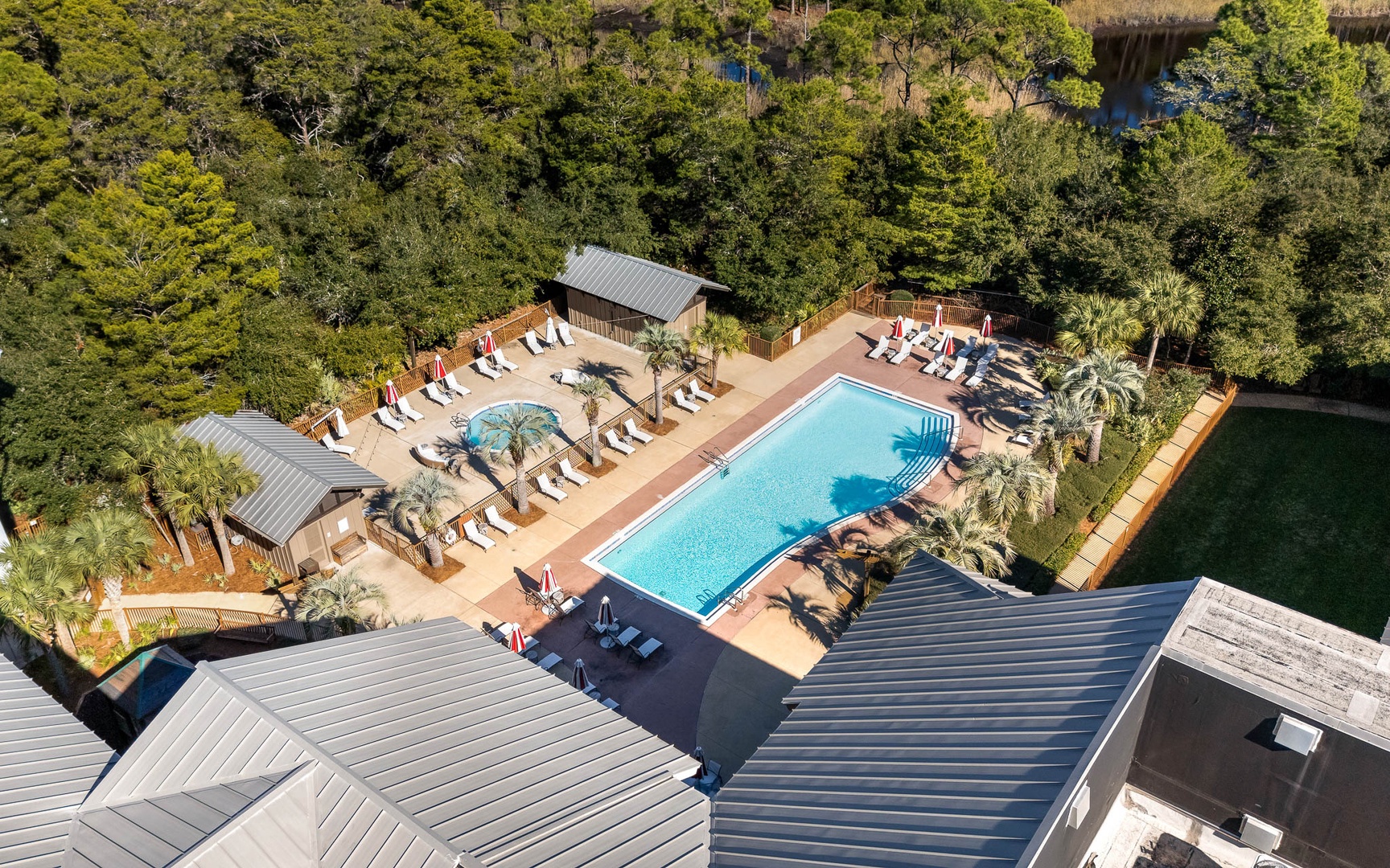 Aerial view showcasing the resort's stunning swimming pool area surrounded by lush tropical landscaping and modern amenities.