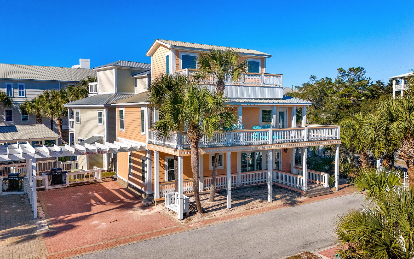 Beautiful coastal property with multi-level balconies and tropical landscaping in a charming beach community setting.