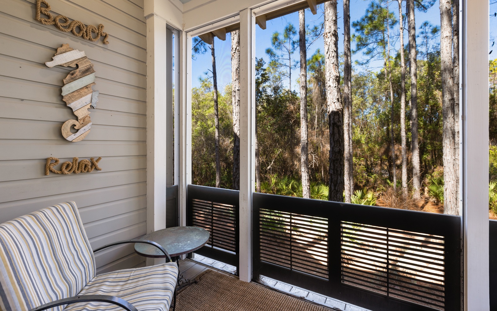 Unwind on your private screened balcony where coastal charm meets forest serenity, perfect for morning coffee with nature views.