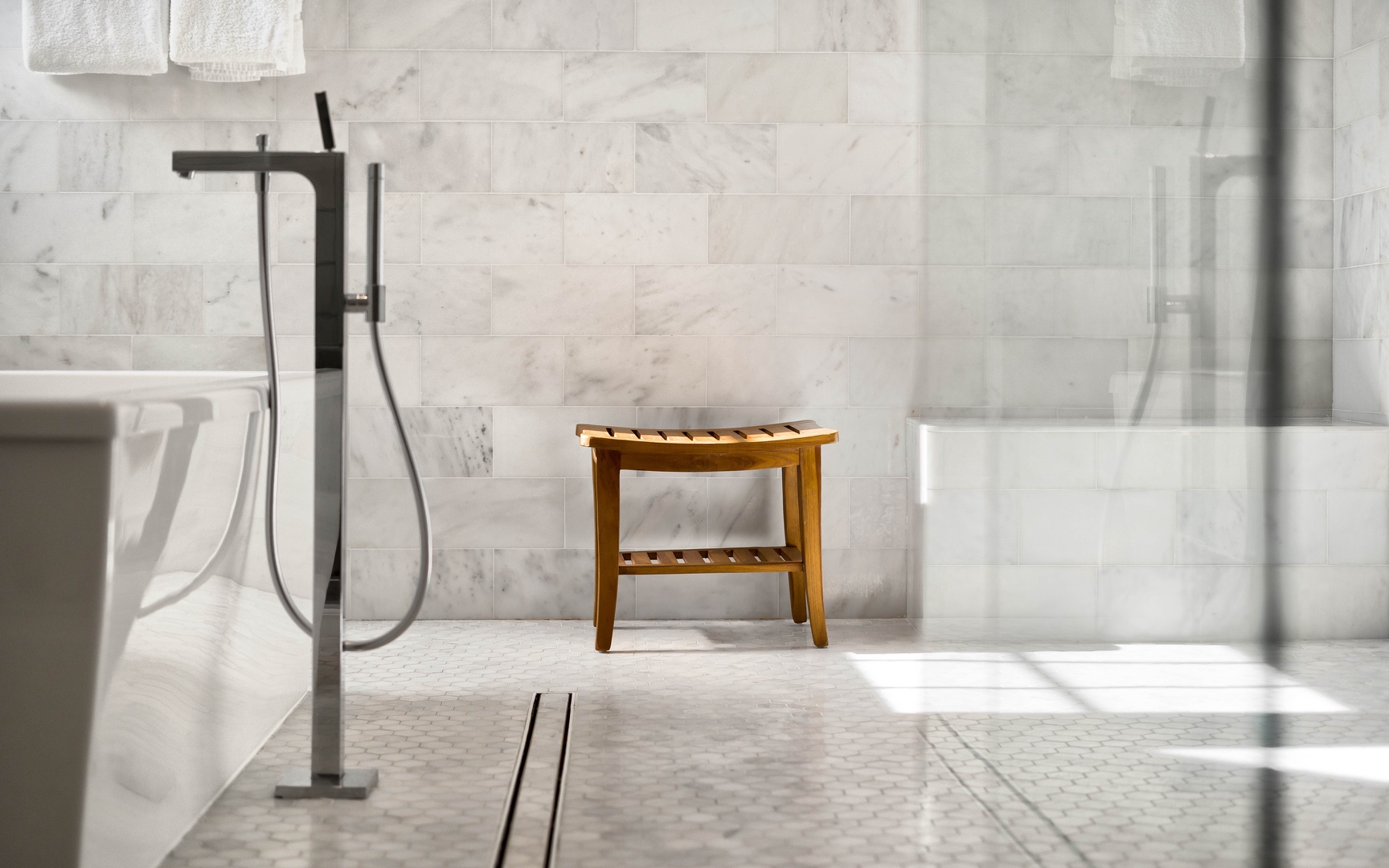 Slip into luxury with your private marble sanctuary, complete with elegant fixtures and warm natural light streaming through.