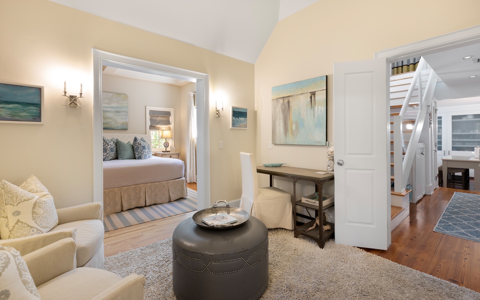 Relax in your elegant suite where coastal charm meets comfort—your private bedroom awaits beyond the inviting sitting area.