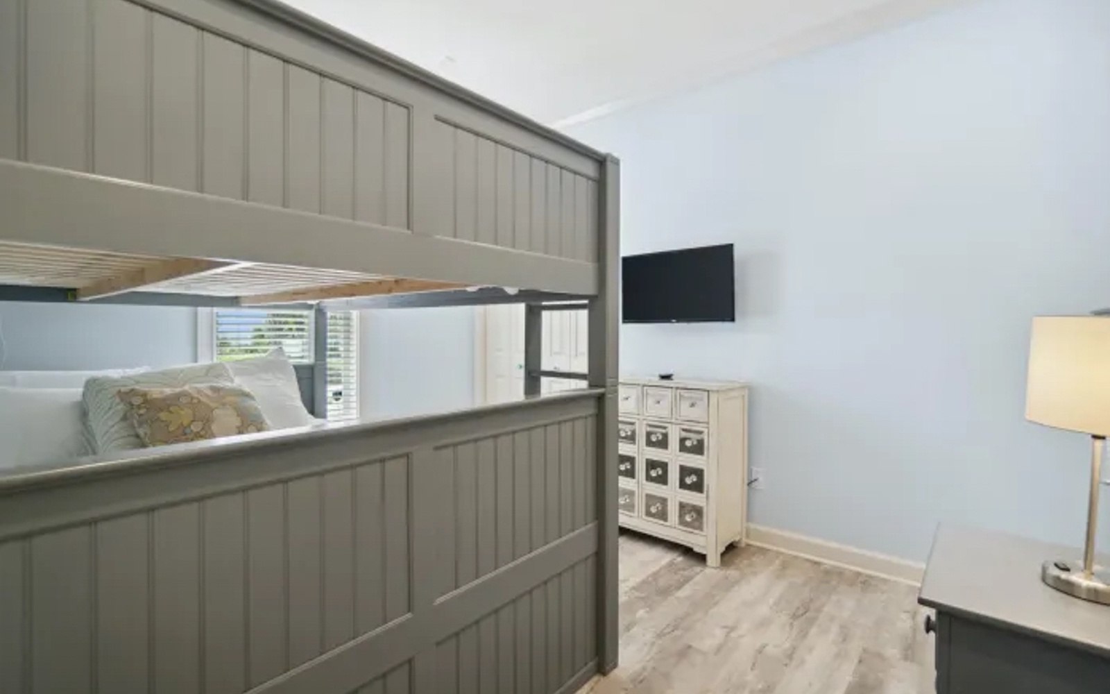 Cozy bunk beds offer perfect sleeping spots with your own TV for nighttime entertainment and dresser storage.