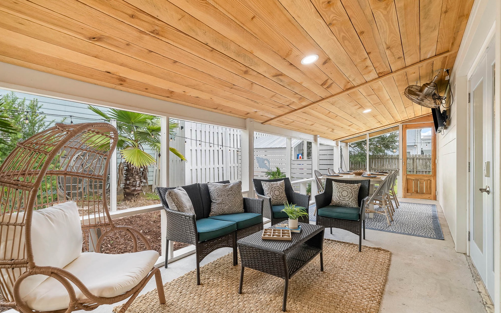 Unwind in your covered patio with plush seating and charming garden views for peaceful outdoor relaxation.