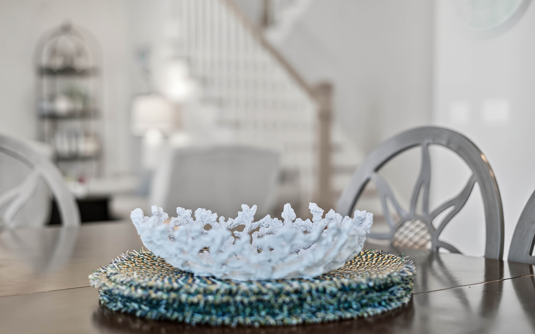 Admire elegant touches like this delicate coral bowl centerpiece while you dine at your stylish glass table.