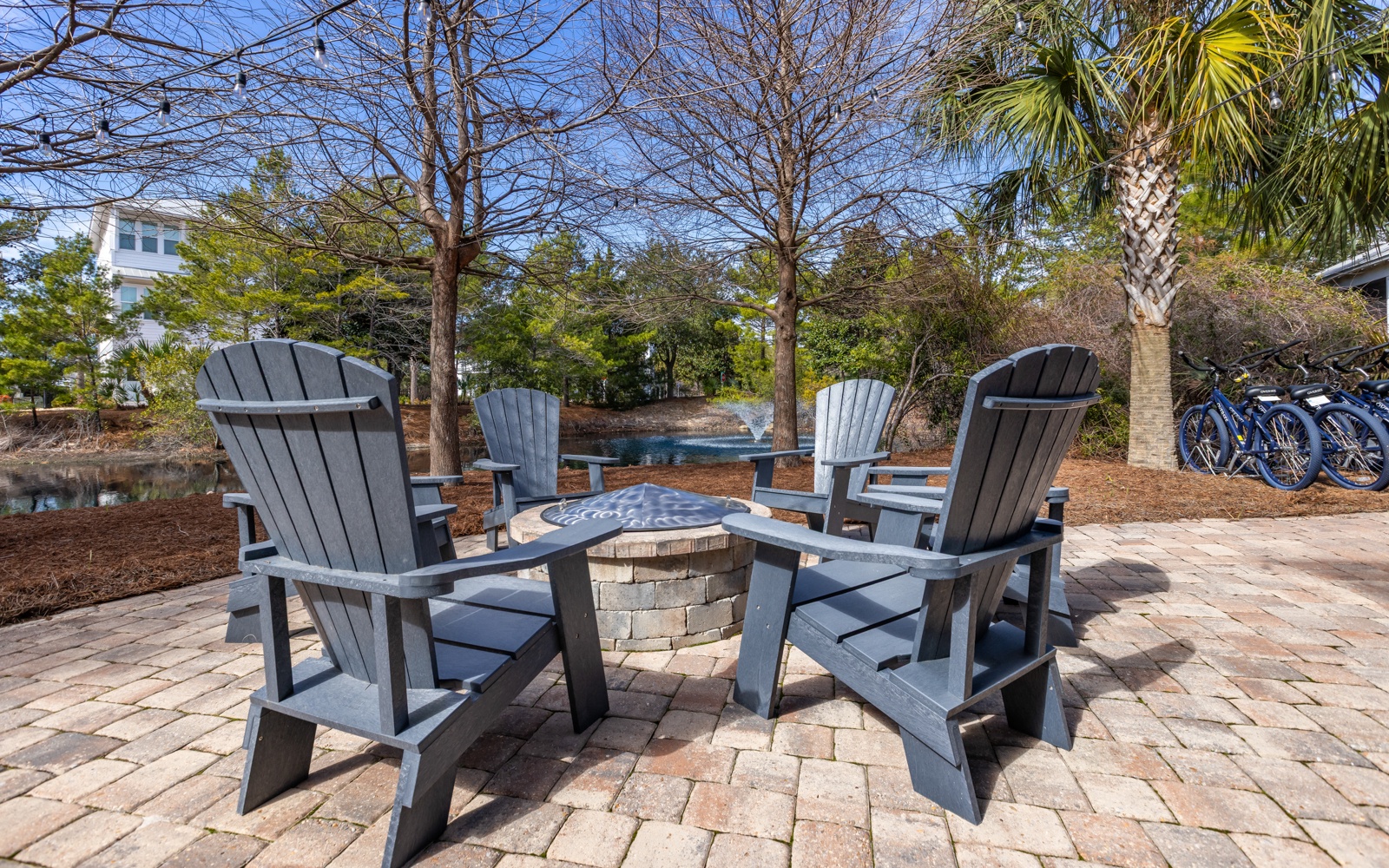 Gather around your private fire pit on this brick patio, surrounded by comfortable Adirondack chairs perfect for evening conversations under the stars.
