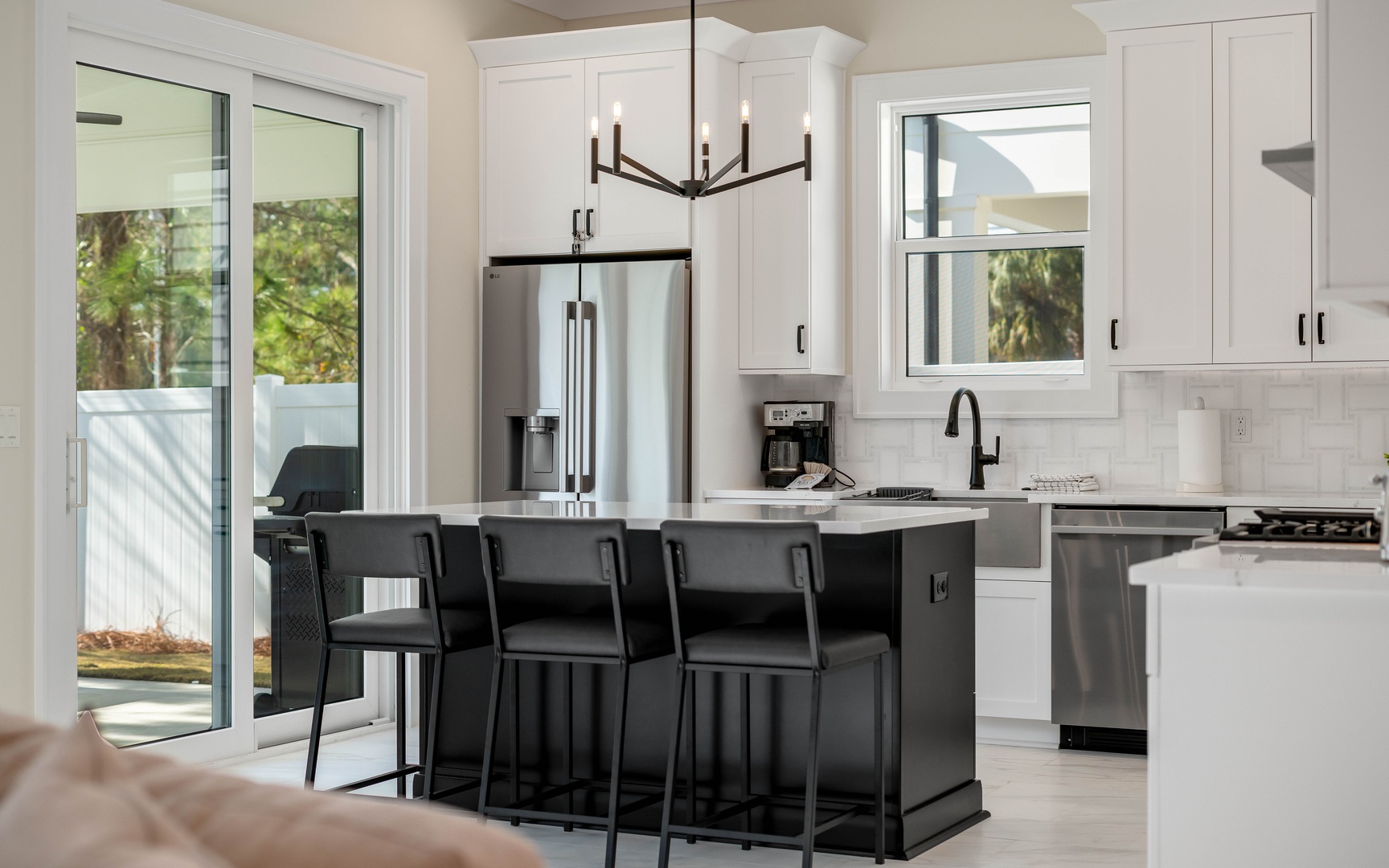 Cook and entertain with ease in your modern kitchen featuring stainless appliances, marble counters, and a spacious island for gathering.