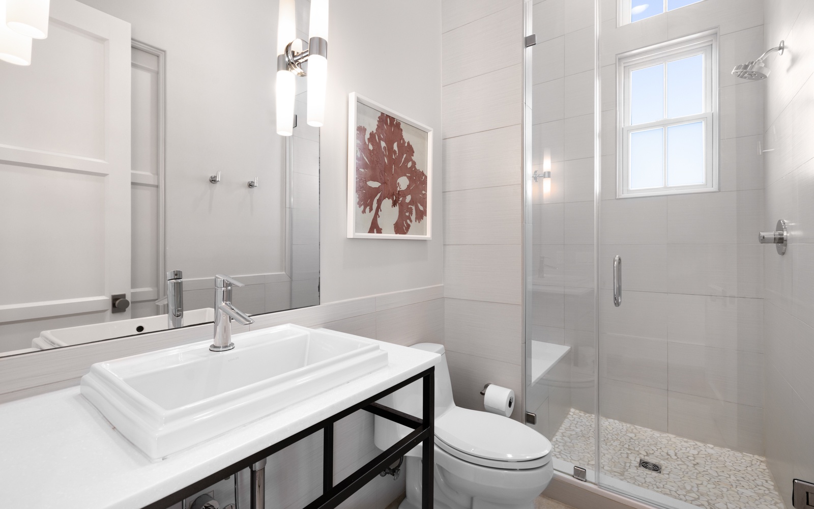Step into your pristine bathroom with marble-style tiling, modern fixtures, and a glass-enclosed shower that makes your morning routine feel luxurious.