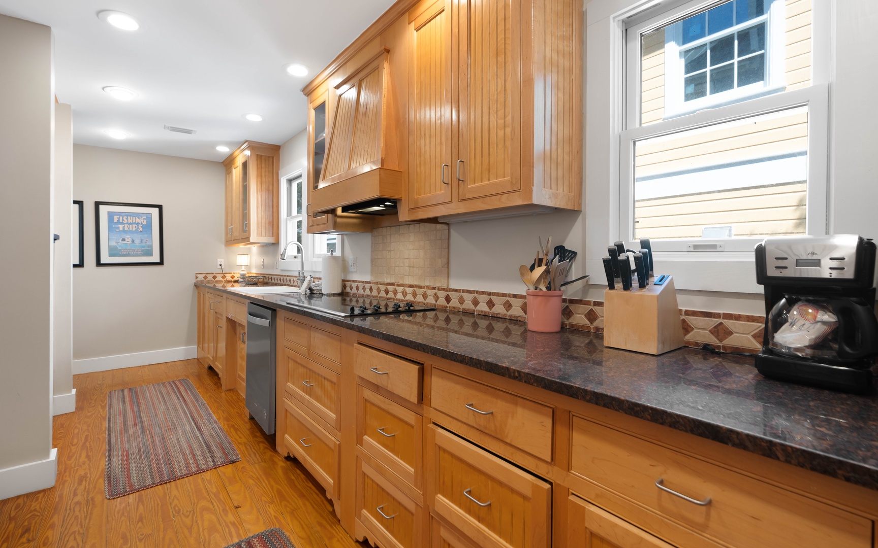 Prepare delicious meals in your spacious kitchen featuring warm wood cabinets, granite counters, and modern appliances.