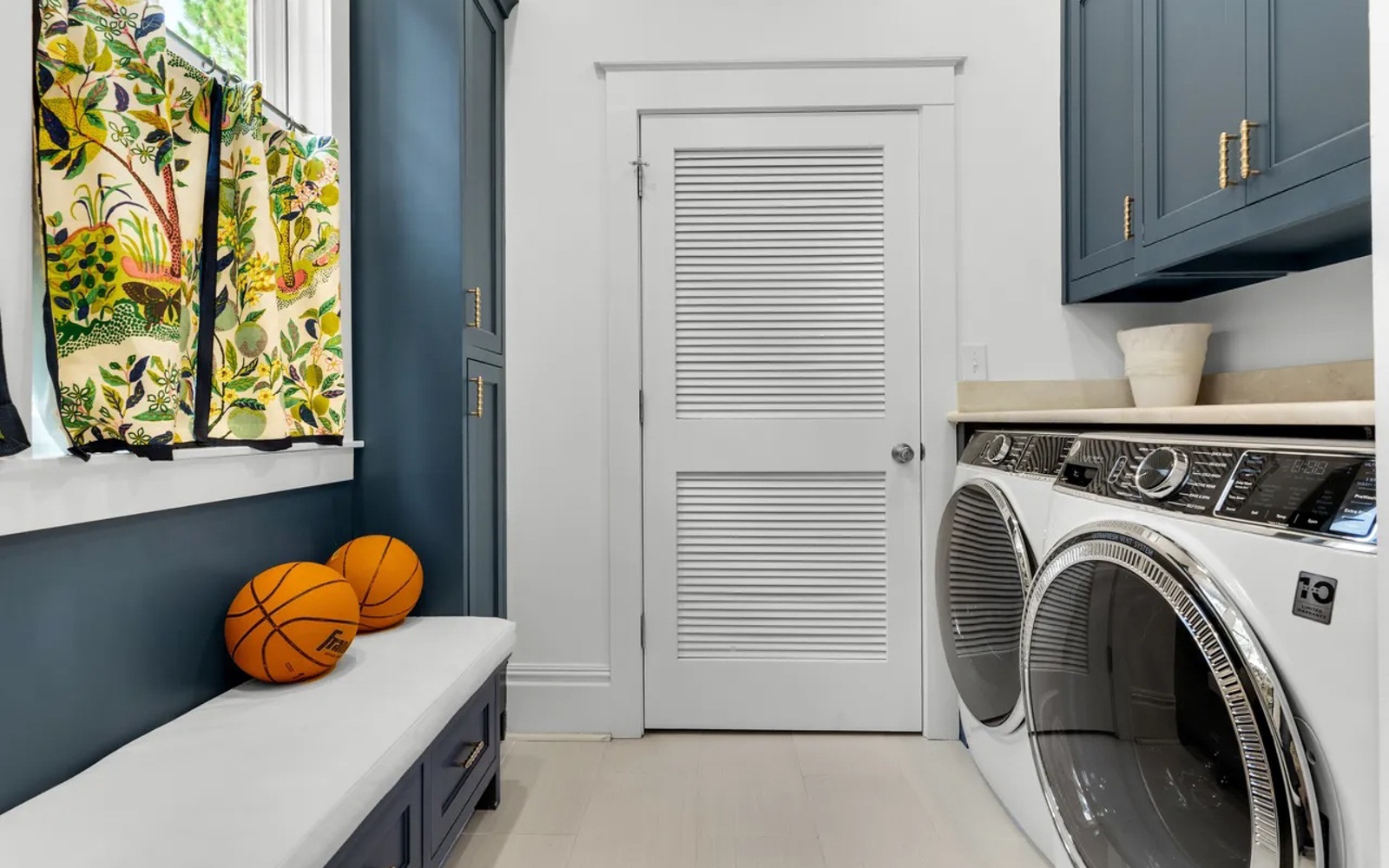 You'll love this cheerful laundry room featuring modern appliances and vibrant tropical decor to brighten your stay.