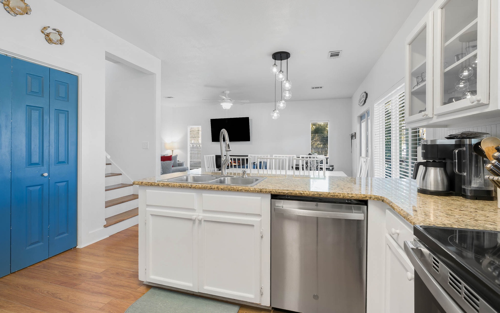 Your open kitchen flows seamlessly into the bright living space, featuring granite counters and stainless appliances perfect for preparing vacation meals.