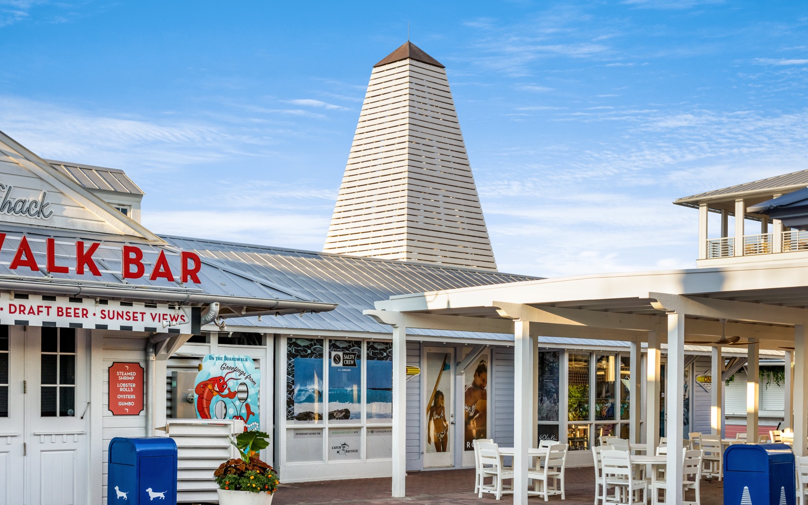 Charming boardwalk dining awaits with casual coastal eateries and bars featuring fresh seafood, craft beers, and stunning sunset views in this vibrant waterfront district.
