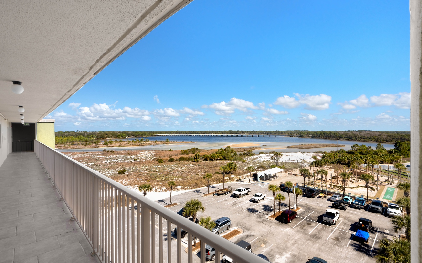 Spectacular waterfront views from this elevated balcony showcase the expansive bay, bridge, and coastal landscape.