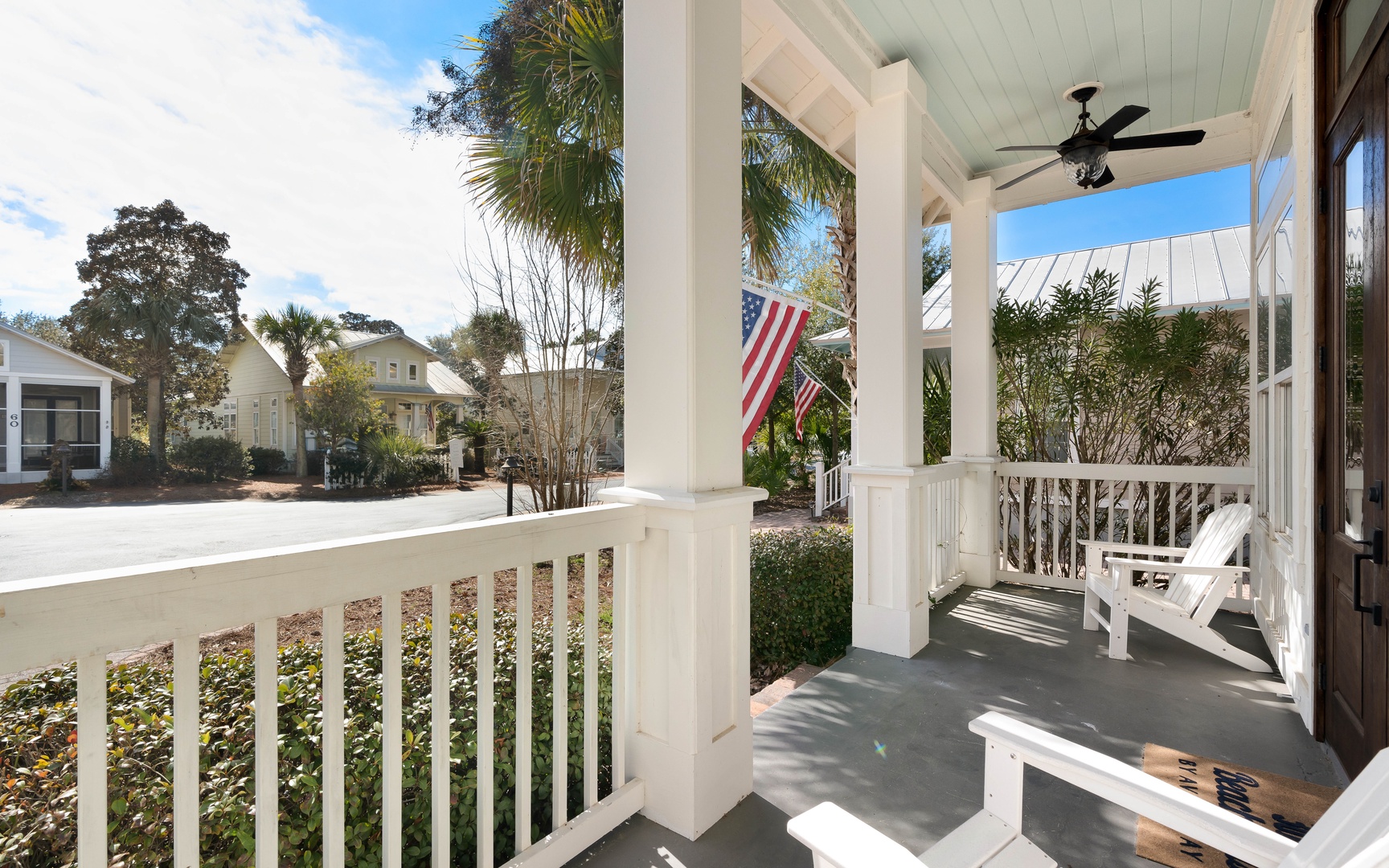 Relax on your charming covered porch with comfortable seating while enjoying the peaceful neighborhood views and gentle breeze from the ceiling fan overhead.