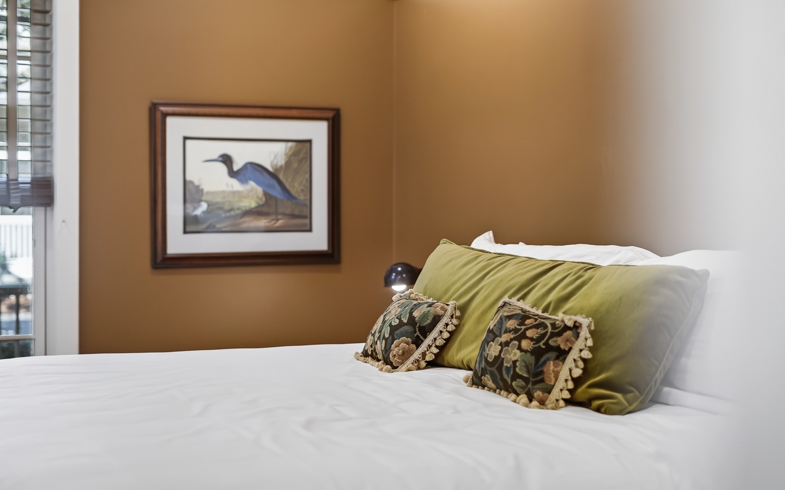 Sink into crisp white linens with decorative pillows that add warmth to your peaceful retreat.