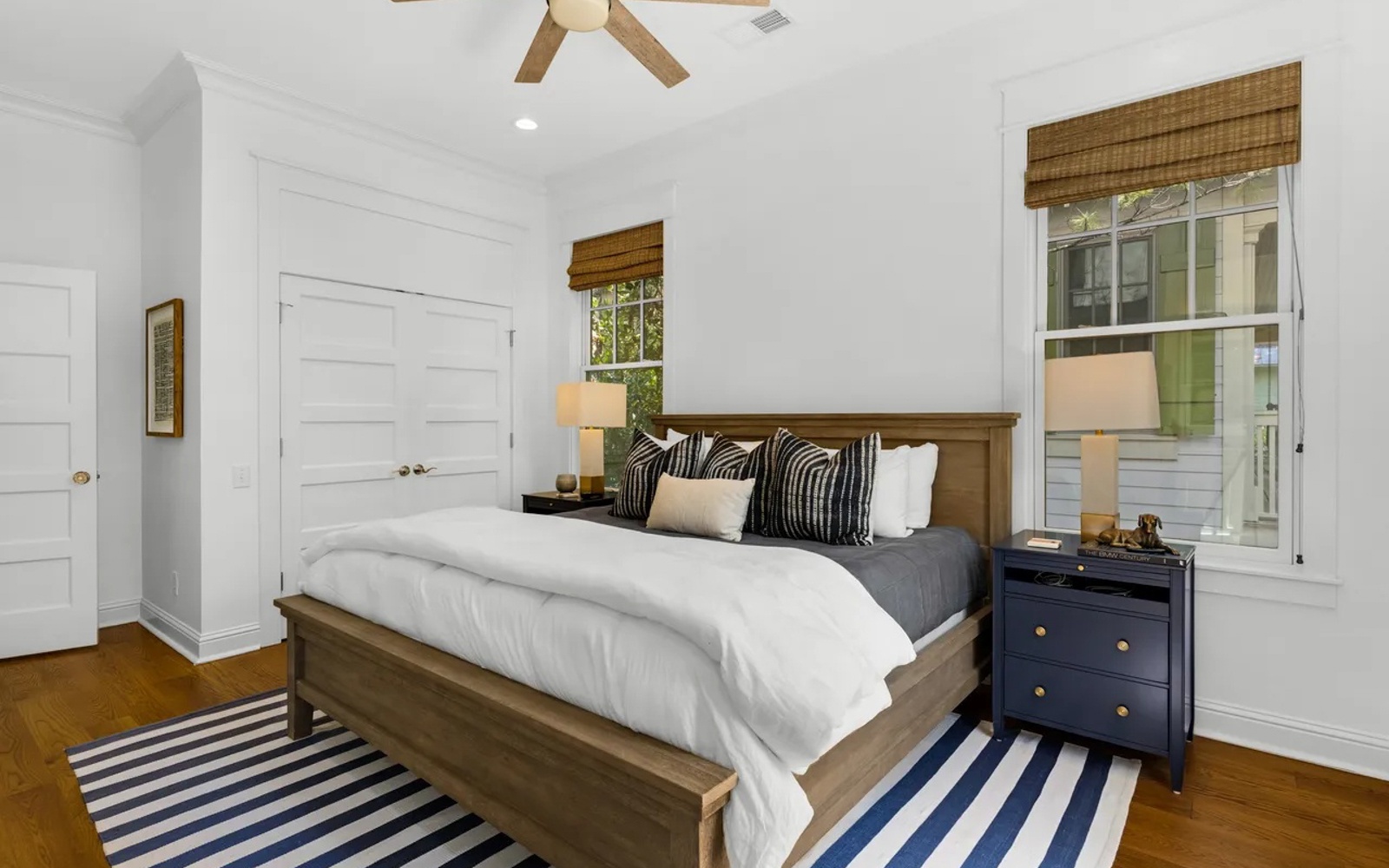 Drift off to sleep in your cozy bedroom featuring crisp white linens, wood accents, and charming nautical touches.