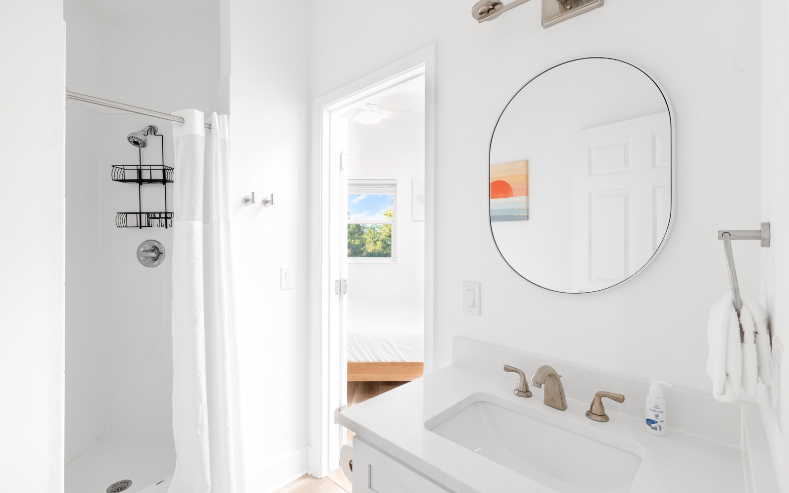 Step into your bright, modern bathroom with a refreshing shower and peaceful garden views through the window.