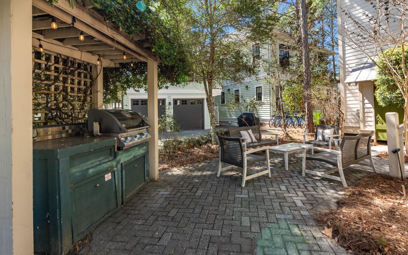 Fire up the grill and unwind in your private outdoor sanctuary, complete with comfortable seating and charming string lights overhead.