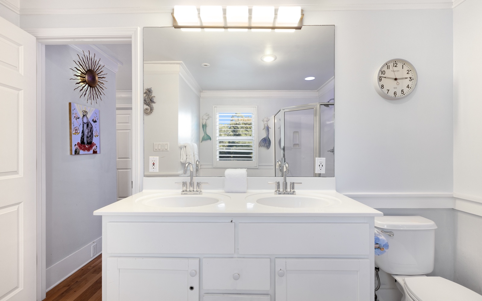 Unwind in your bright bathroom with dual vanities, perfect lighting, and charming coastal touches that make your morning routine a pleasure.