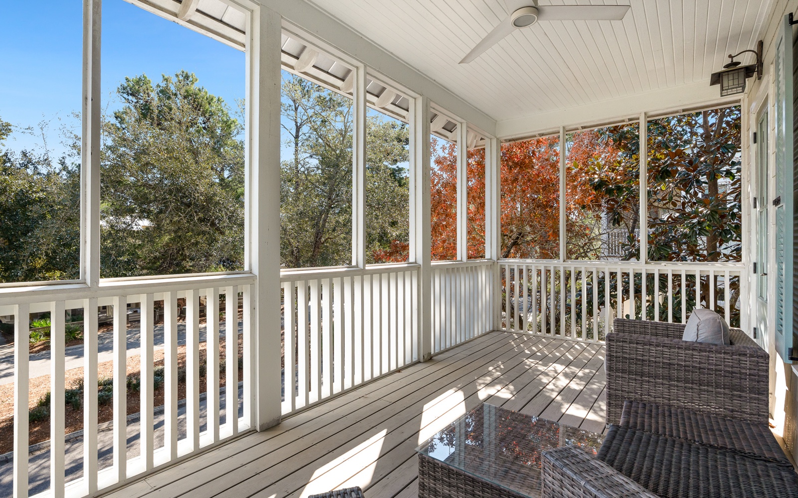 Step onto your private screened porch where autumn leaves create a stunning backdrop for your morning coffee or evening relaxation.