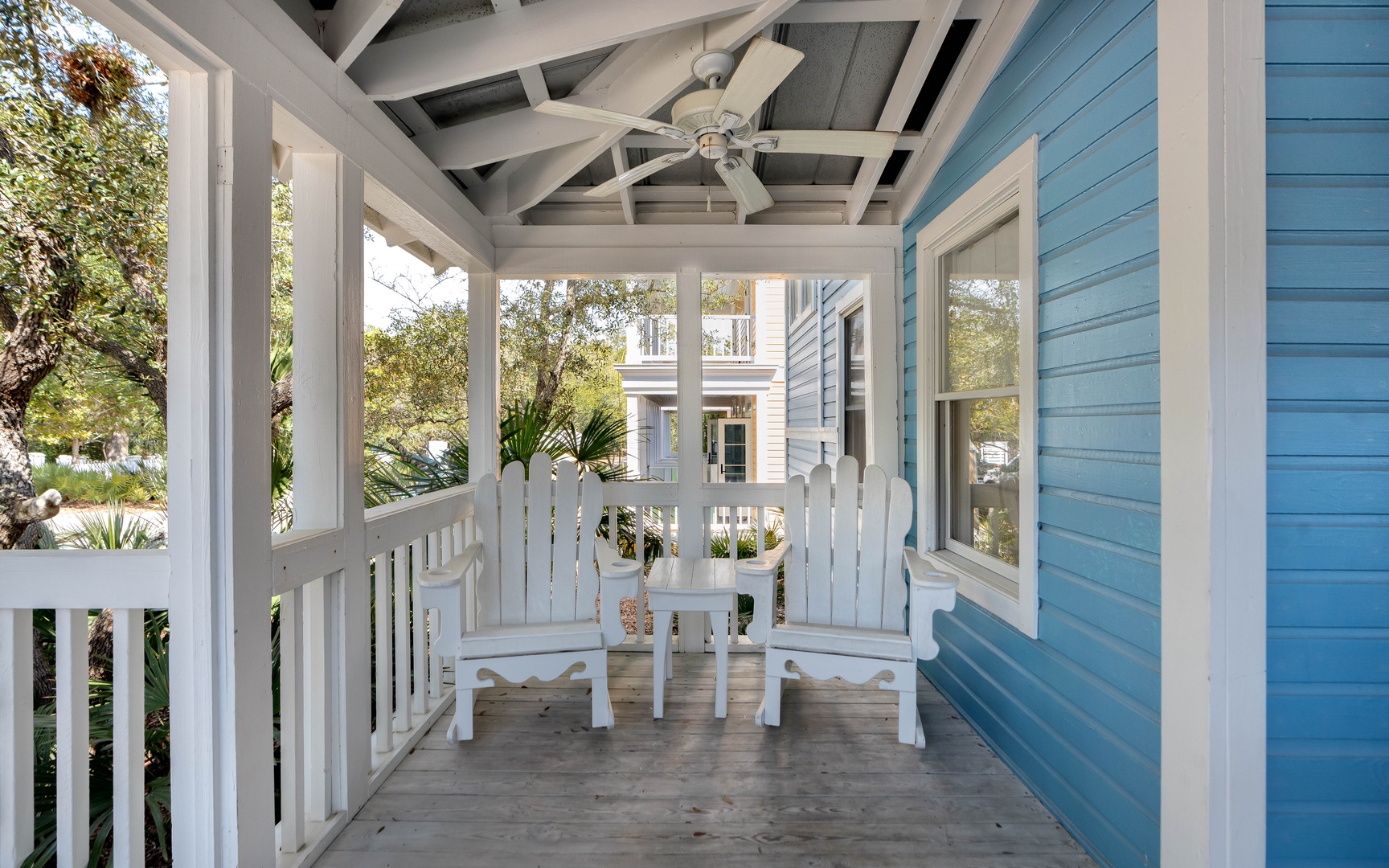 Unwind on your charming covered porch with Adirondack chairs and ceiling fan, overlooking the peaceful neighborhood.