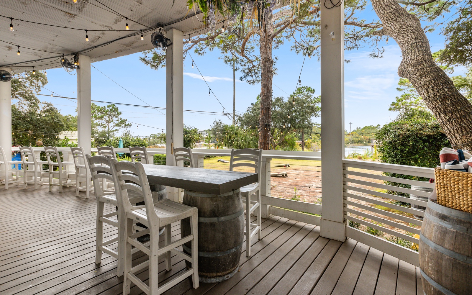 Dine al fresco on your covered deck, where string lights create ambiance as you enjoy meals under the shade of mature trees.