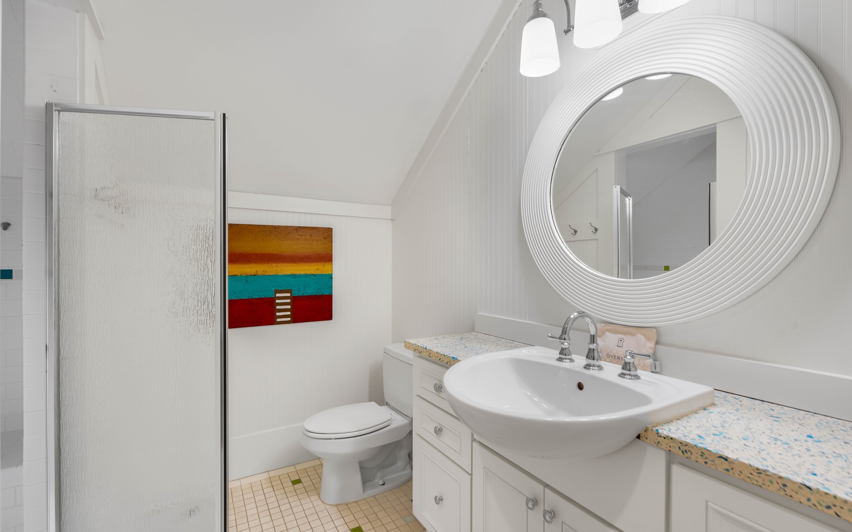 Step into your bright, modern bathroom with a sleek vessel sink and unique circular mirror that adds elegant style to your daily routine.