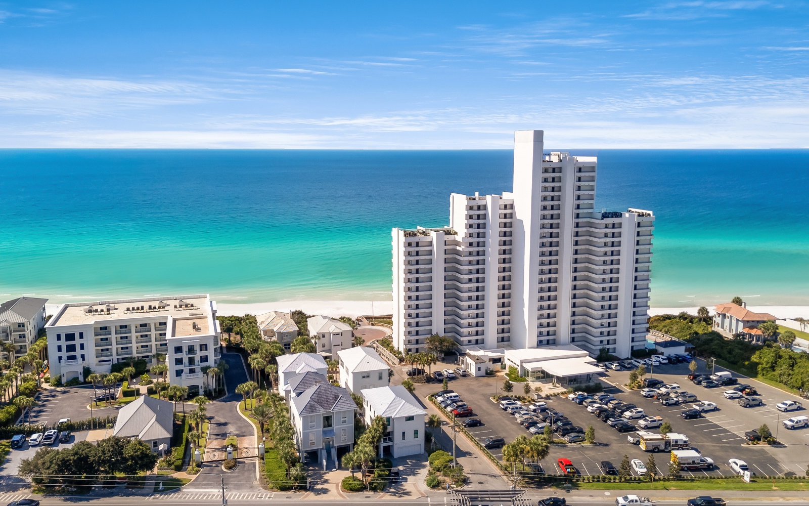 Stunning beachfront towers rise above pristine emerald waters and sugar-white sand, with convenient parking and coastal charm.