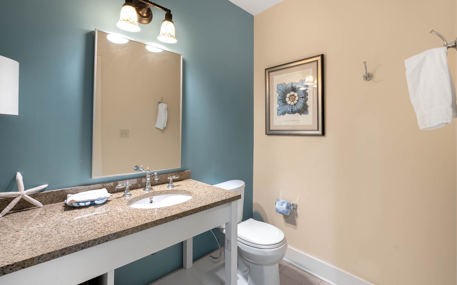 Fresh up in your coastal-themed bathroom with granite counters, elegant lighting, and soft towels waiting for you.