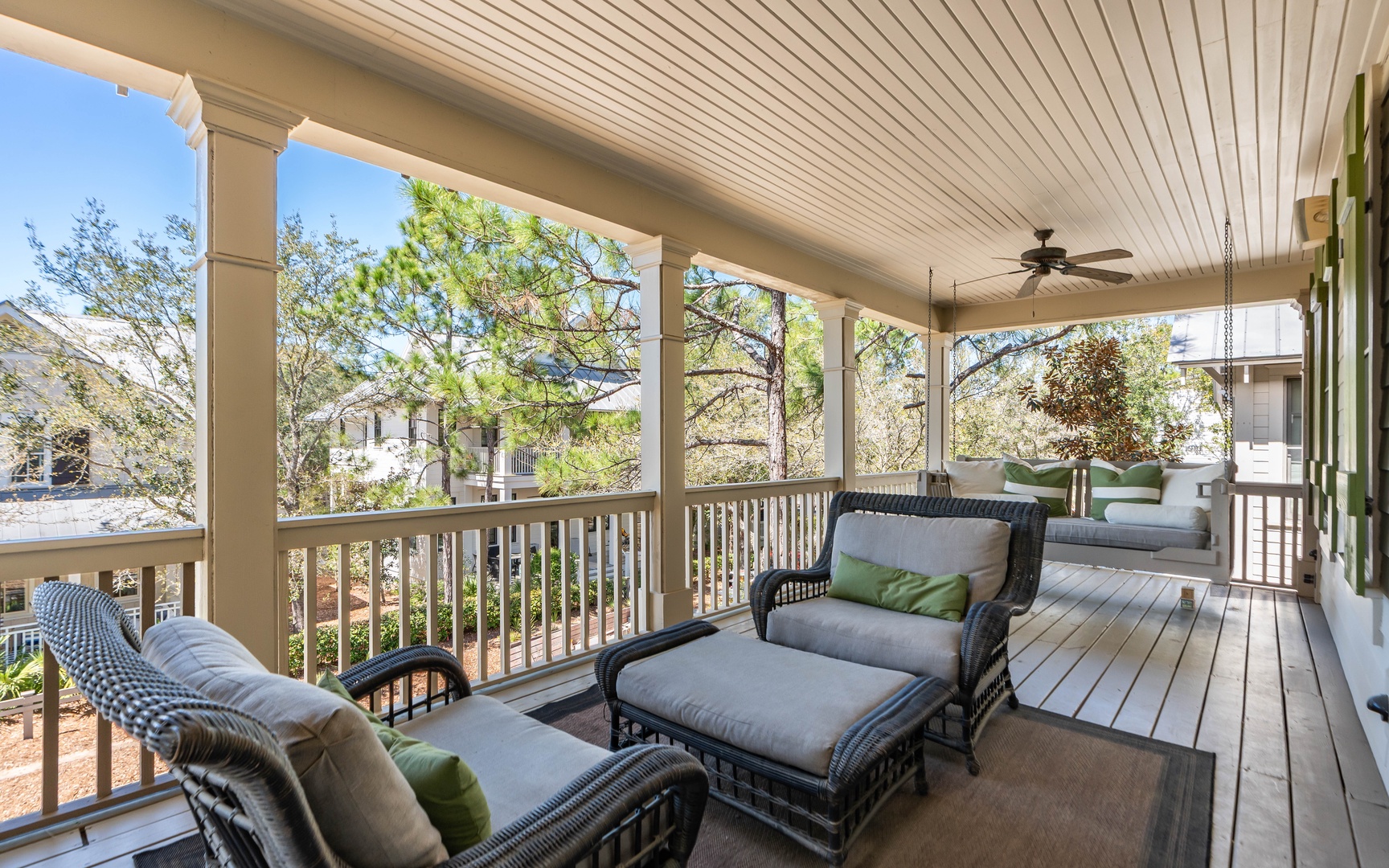 Unwind on your private covered porch where comfortable seating and gentle ceiling fan breezes create the perfect spot for morning coffee.