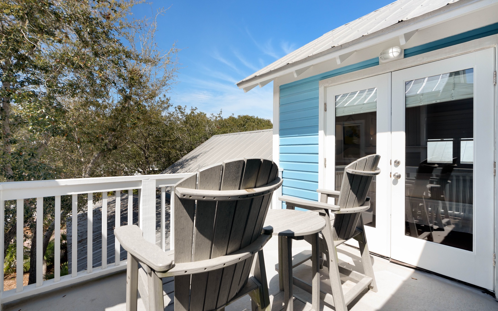 Step onto your private balcony where coastal breezes meet comfortable Adirondack chairs—perfect for morning coffee or evening relaxation.