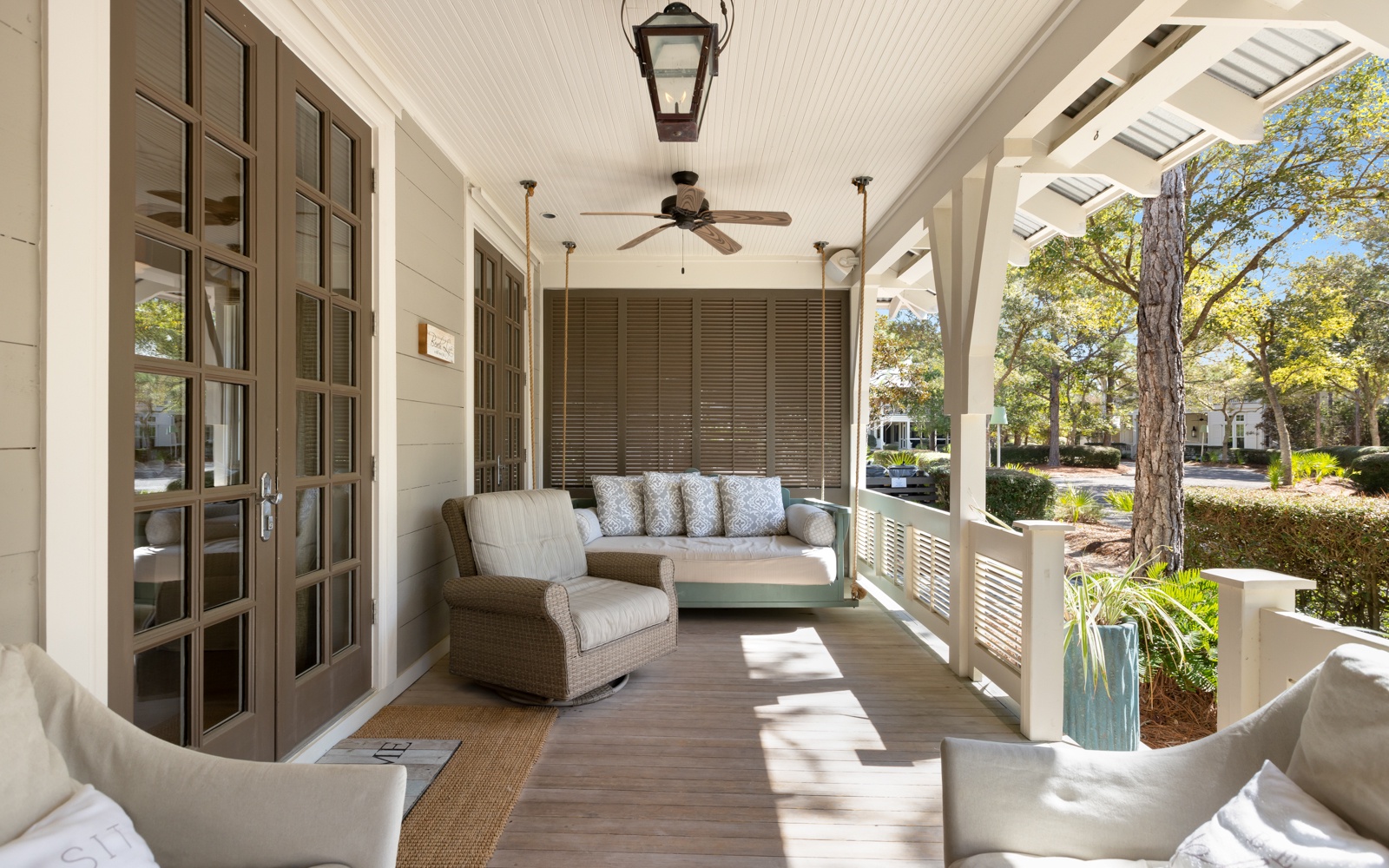 Relax on your private covered porch with comfortable seating, ceiling fans, and peaceful garden views.