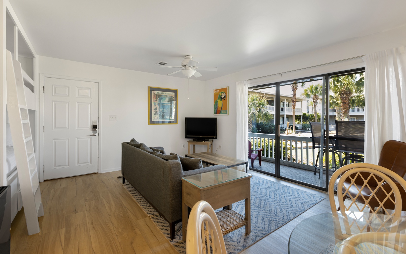 Relax in your bright, airy living space with comfortable seating and direct balcony access to tropical views.